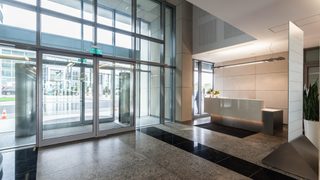 Automatic glass pedestrian doors in a modern commercial building lobby