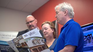 people reviewing product brochure