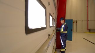 CDS technician maintaining commercial sectional door