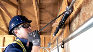 CDS technician servicing garage door spring