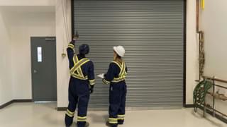 CDS technicians inspecting pedestrian fire door