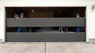 CDS technicians installing garage door panel