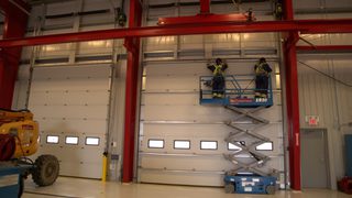 CDS technicians installing sectional commercial doors