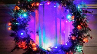 Christmas Wreath With Lights Hanging On A Garage Door