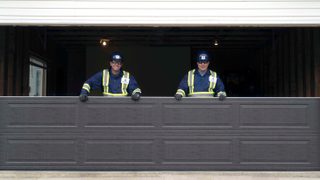 technicians fixing residential garage door
