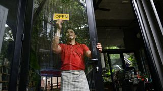 Small Business Cafe Owner At Entrance Min