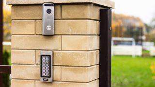 Video intercom and keypad gate access system installed on brick post for secure entry control