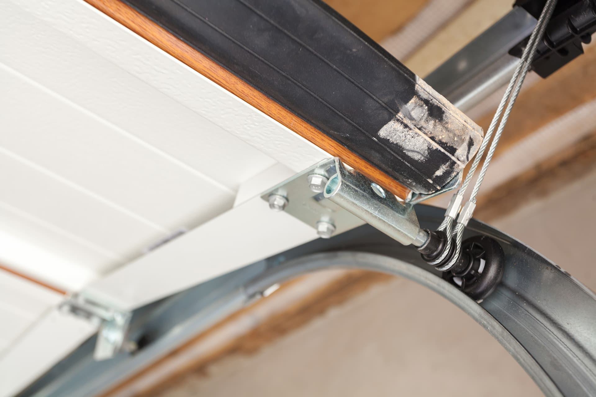 closeup of garage door cable and lifting system