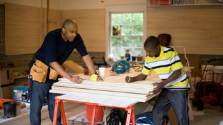 Father And Son Working In Garage Min