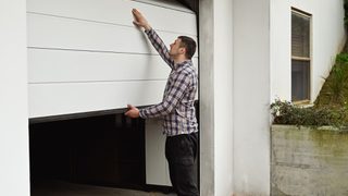 Homeowner opening garage door