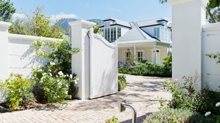 Modern white gate in bloom min