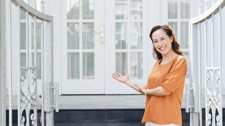Smiling Welcoming Woman Home Gate Min