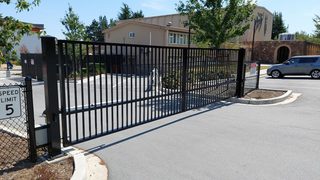 Swing gate for property parking lot entrance