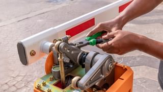 Technician repairing barrier gate arm