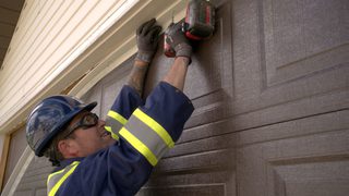 Tecnician Installing Garage Door