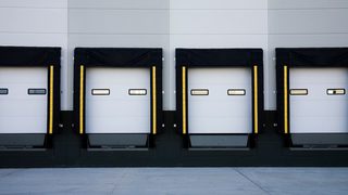 Truck loading dock with automated levelers