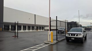 Warehouse with perimeter security gate