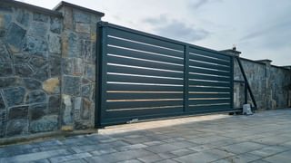Wide automatic sliding gate and brick wall