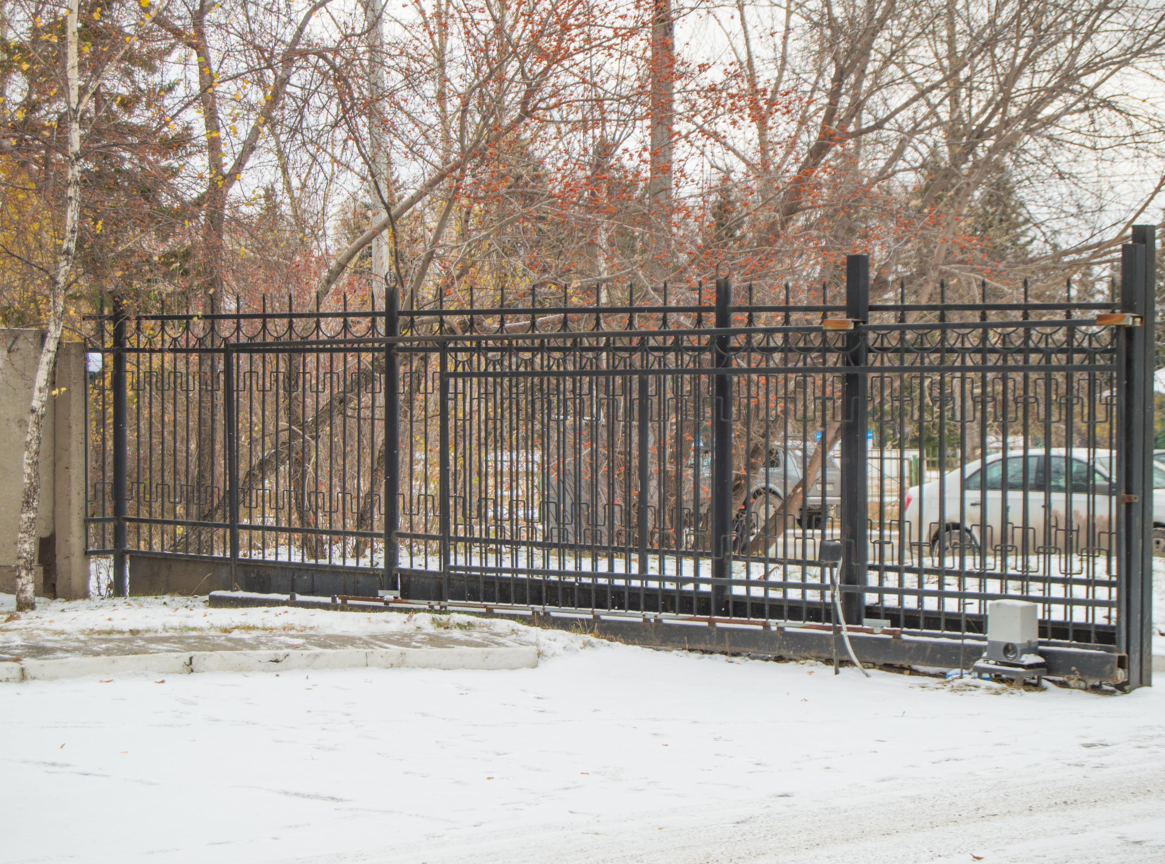 Automatic security gate with metal lattice in snow