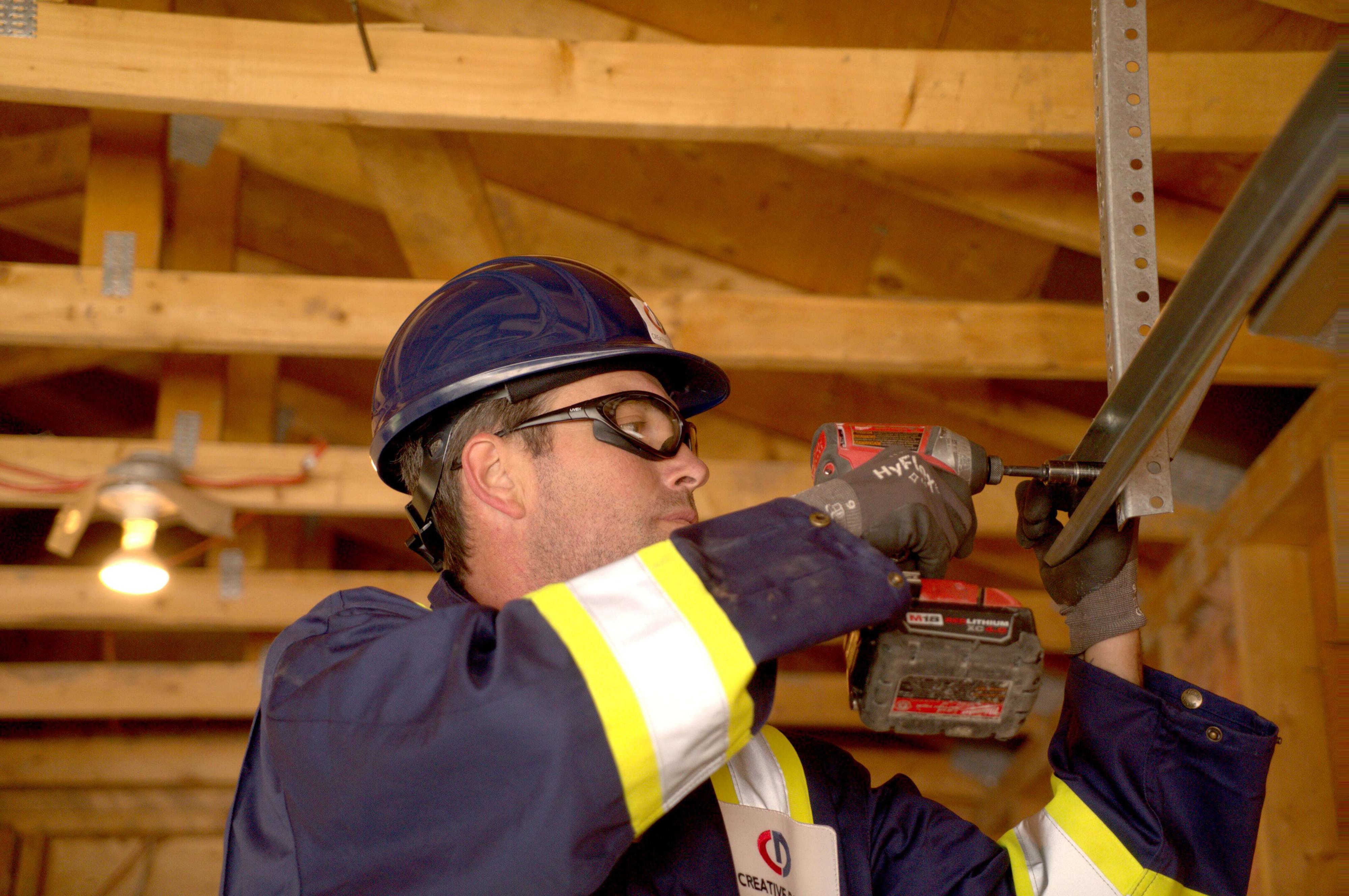 Creative Door Services technician installing rear track hangers