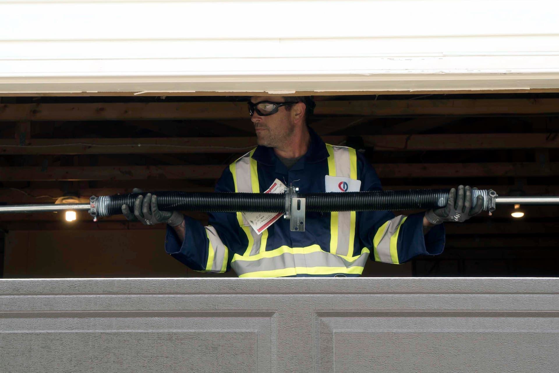 CDS technician holding garage door spring