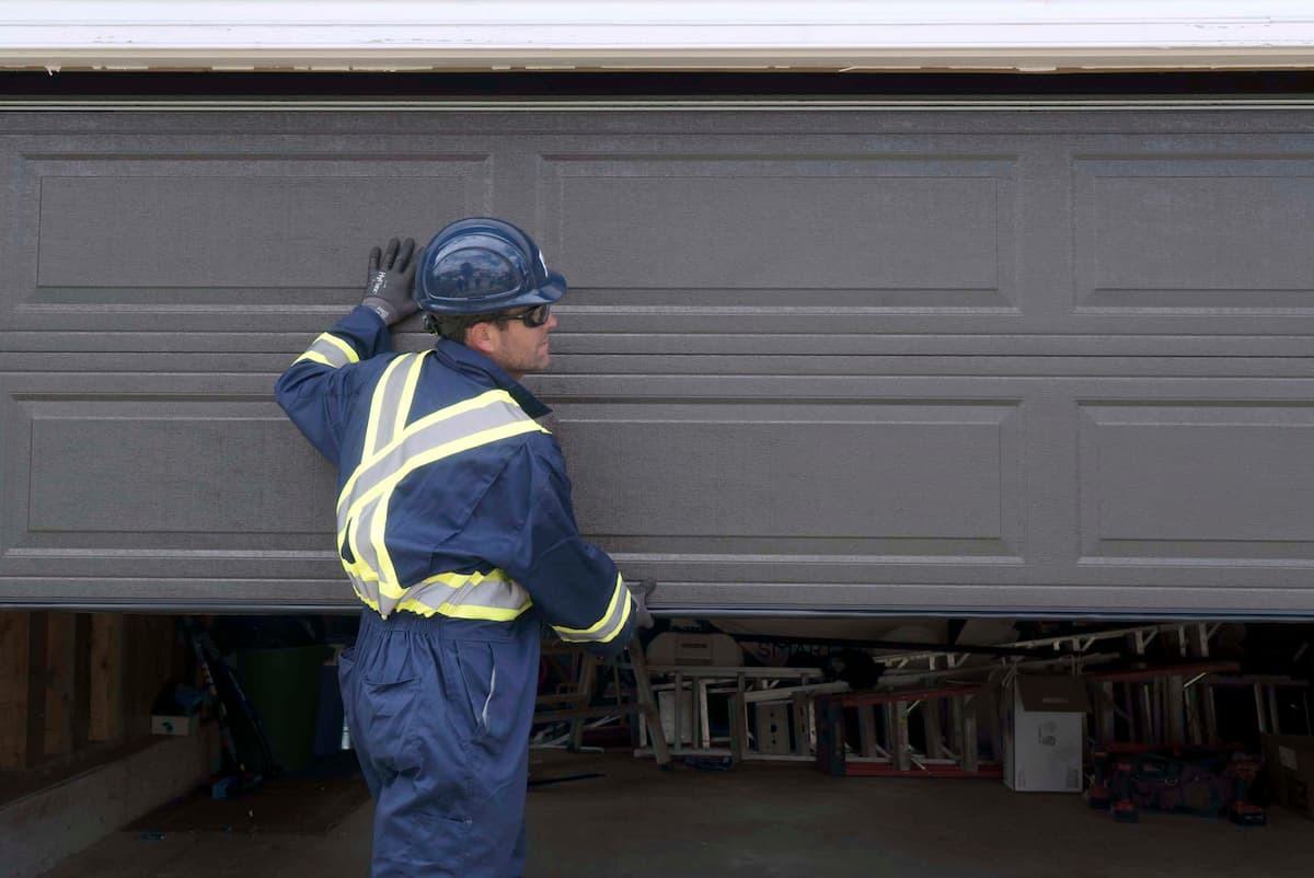 Creative Door Services technician inspecting residential garage door