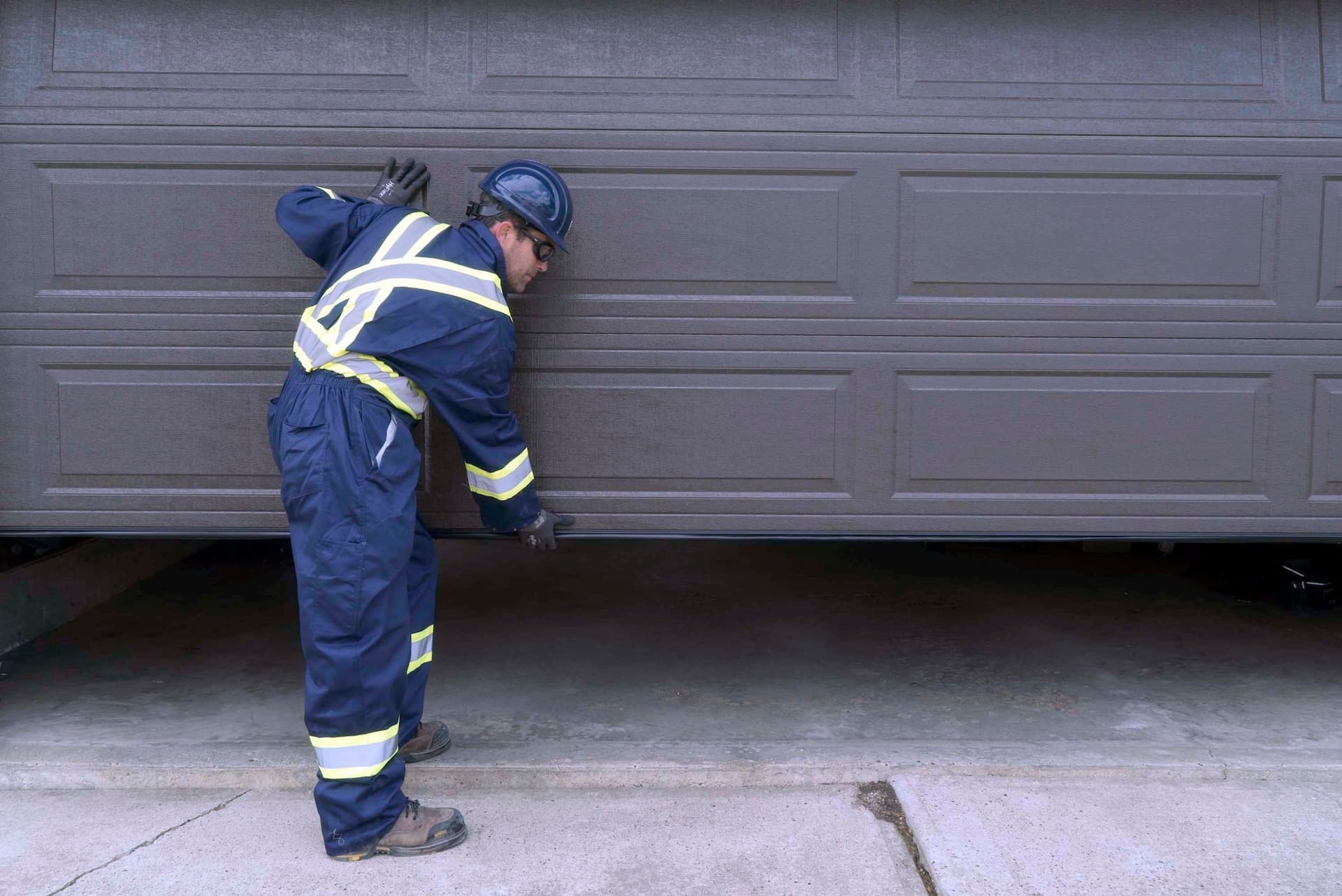 Creative Door Services technician maintaining garage door