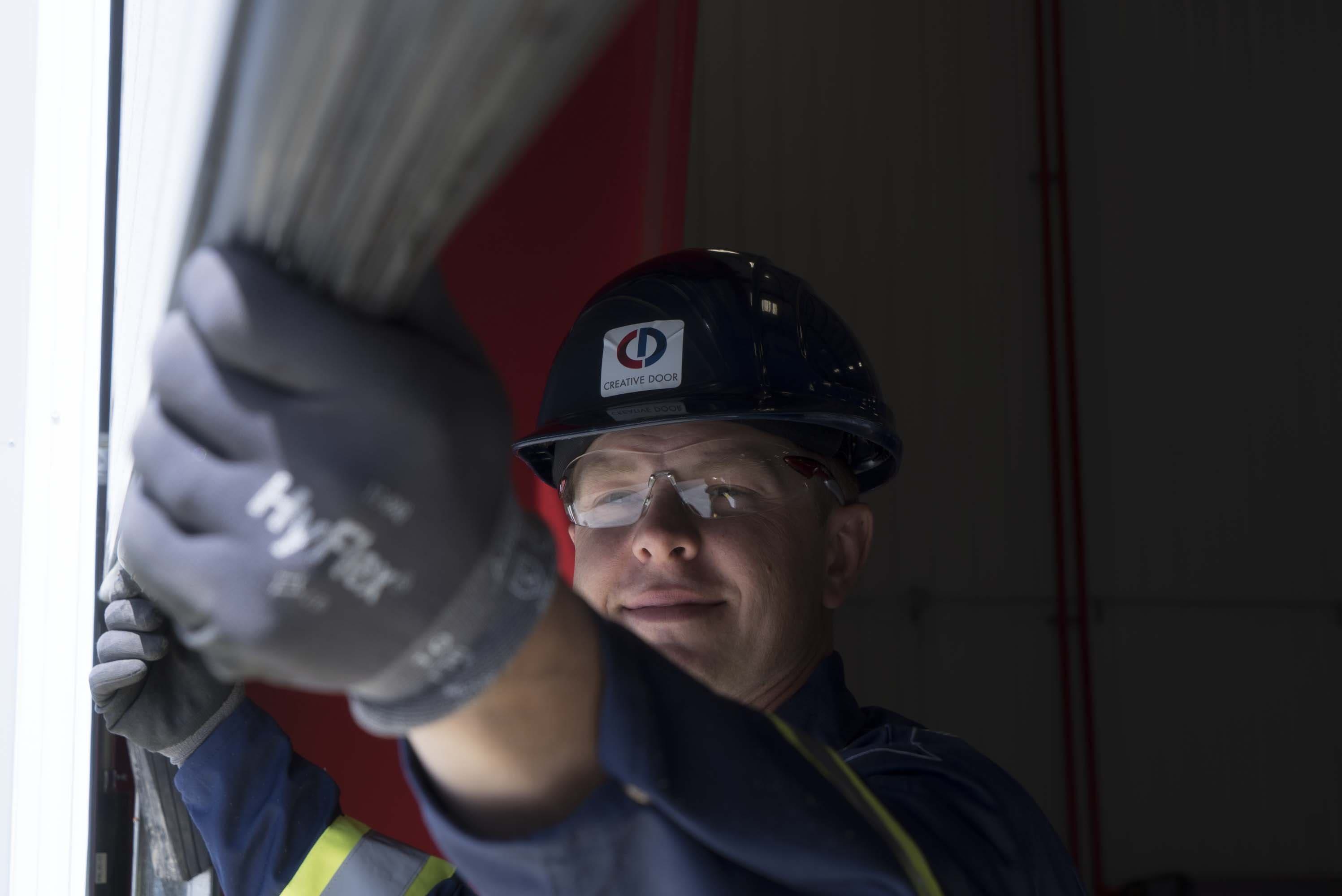Creative Door Services technician maintaining pedestrian door