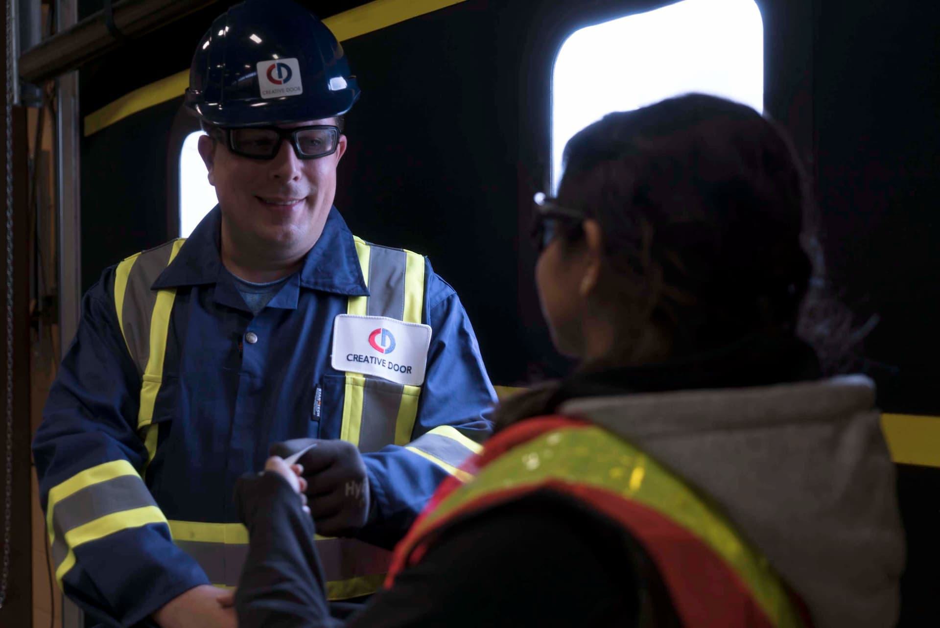 Creative Door Service technician meeting client