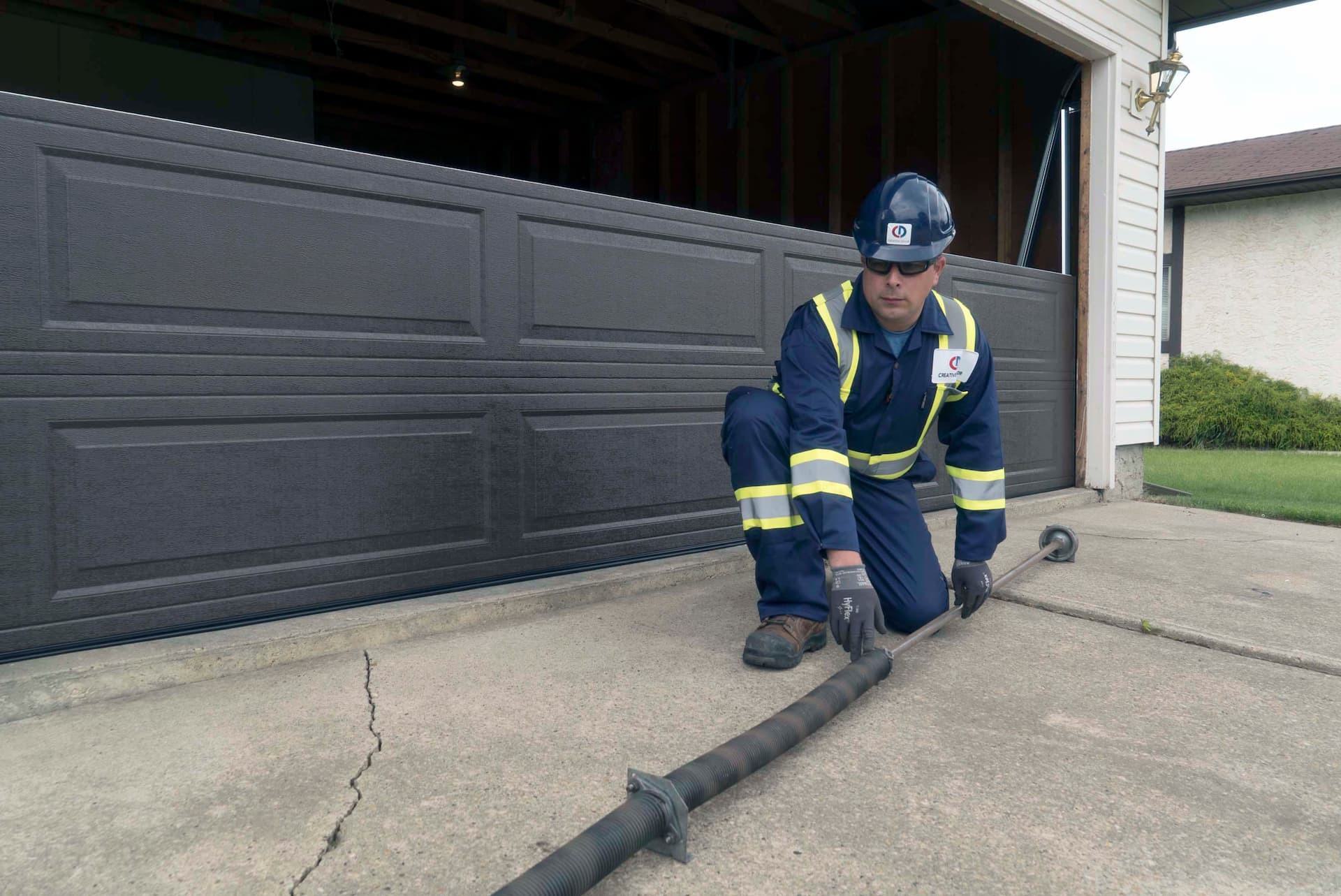 Creative Door technician removing old garage door spring