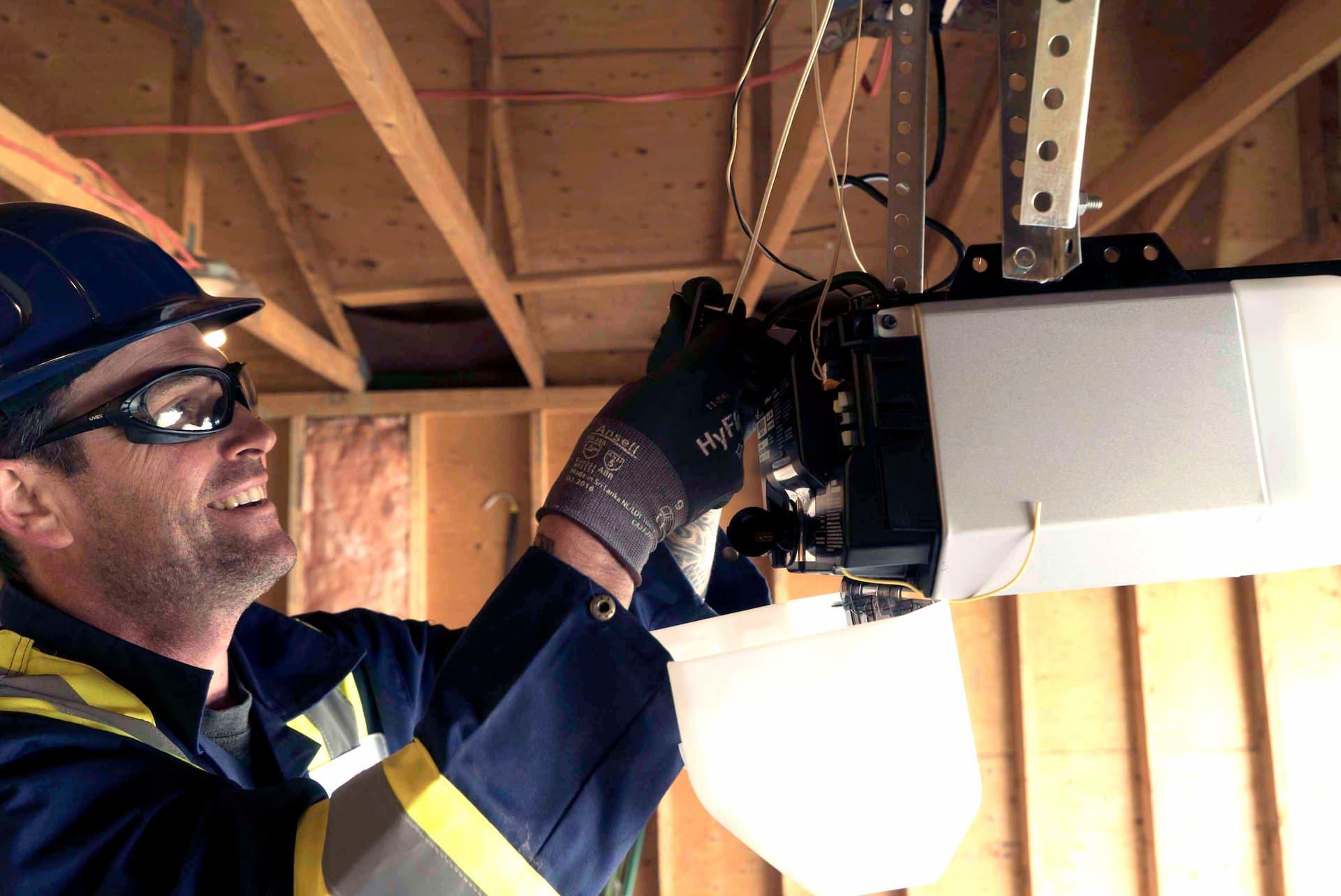 CDS technician repairing a residential garage door opener during maintenance