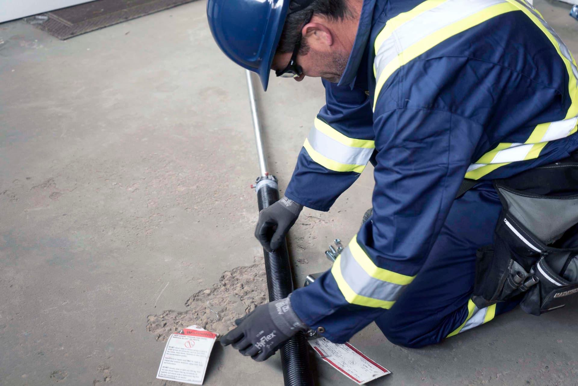 Creative Door technician with new garage door spring