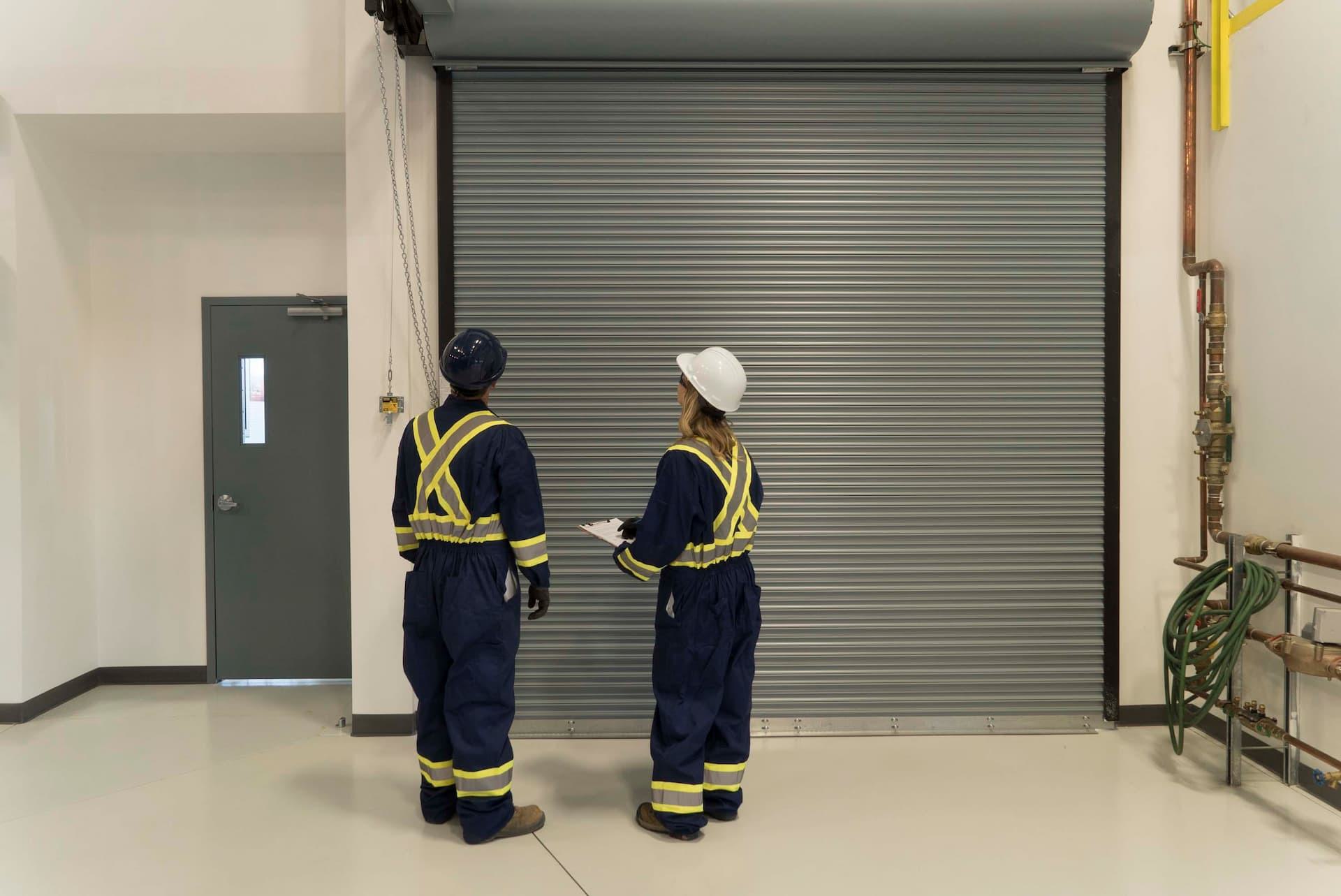 CDS technicians completing installation of pedestrian and rolling door