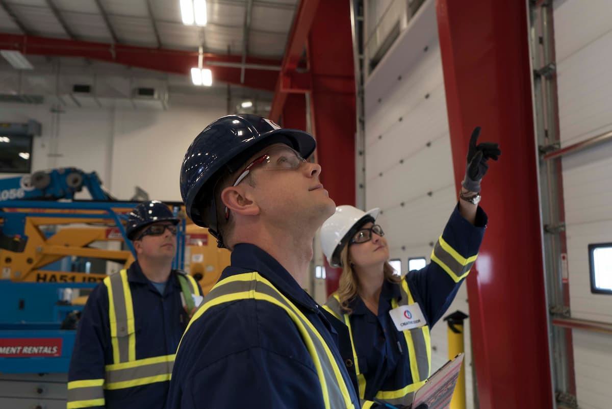 CDS technicians discussing planned maintenance tasks for sectional doors