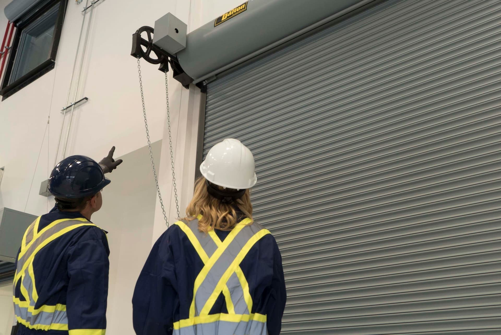 Creative Door Services technicians inspecting a fire door