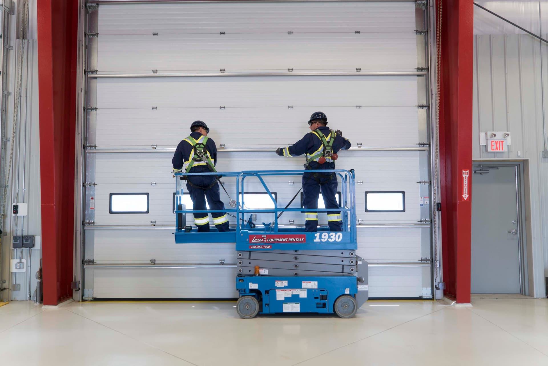 Creative Door technicians installing commercial sectional door