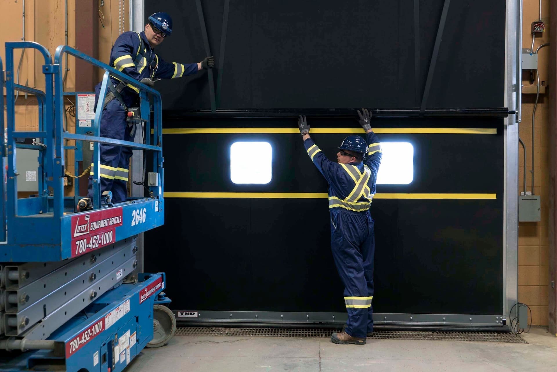 Creative Door Services technicians installing warehouse door and dock equipment