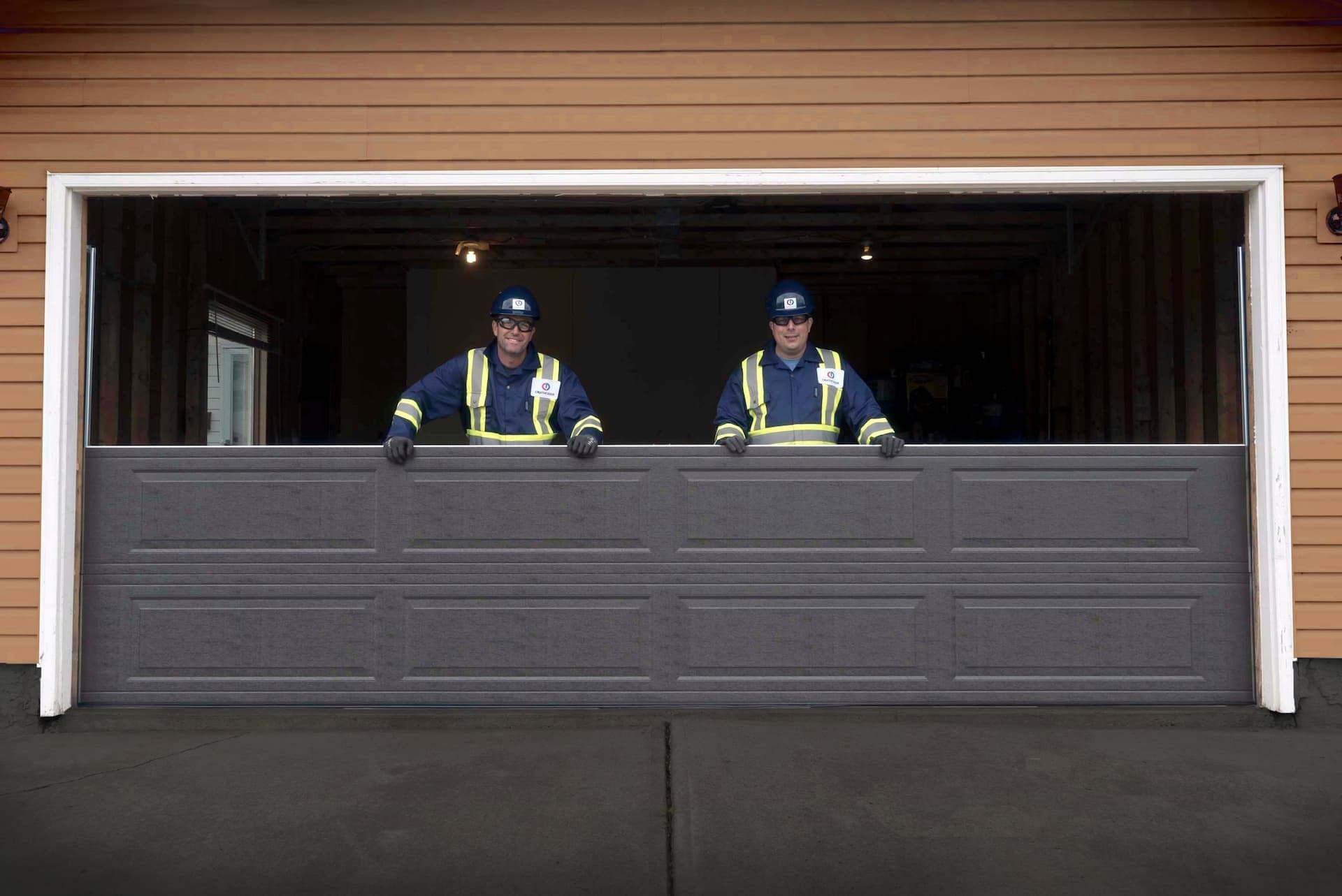 Creative Door Services technicians installing garage door