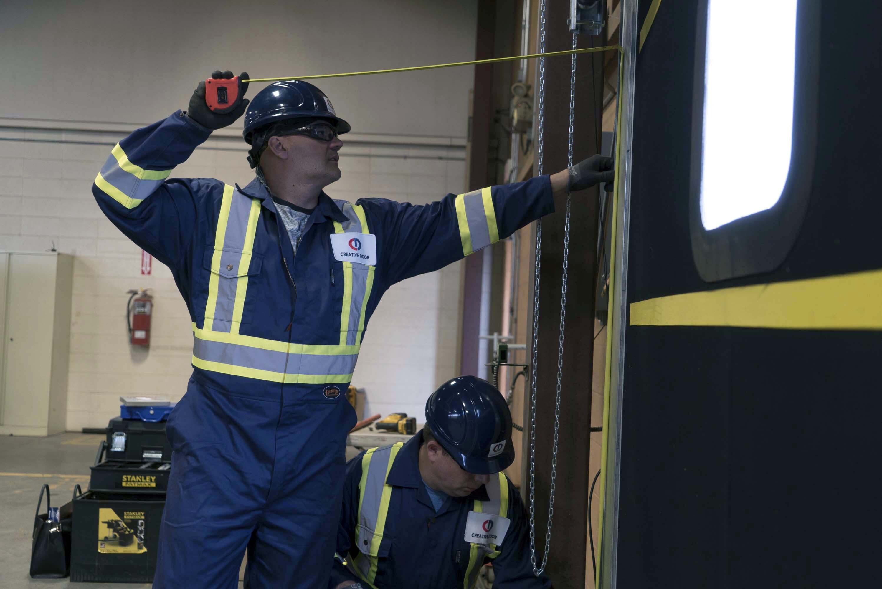 CDS technicians maintaining commercial door