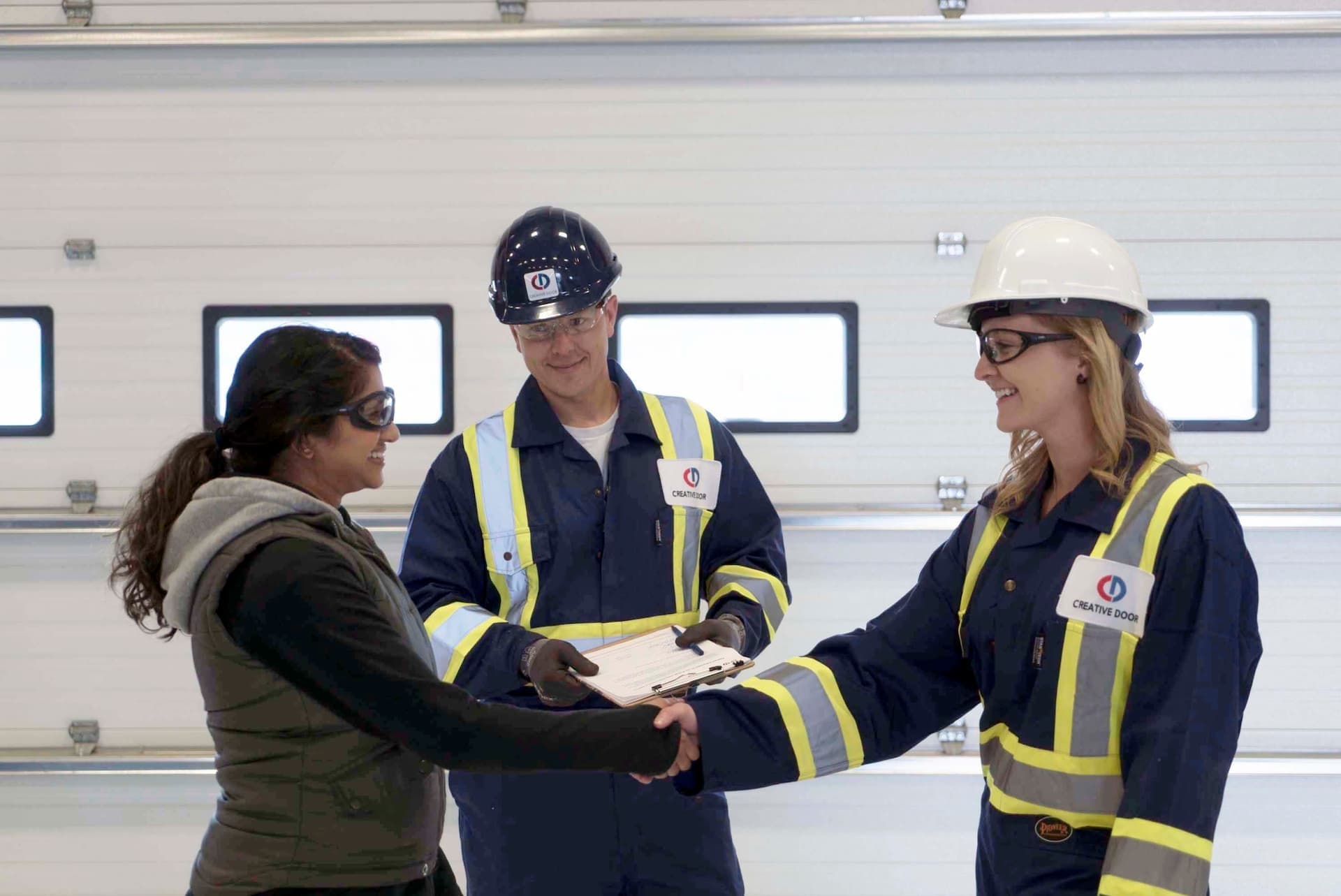 Creative Door Services technicians meeting with commercial client