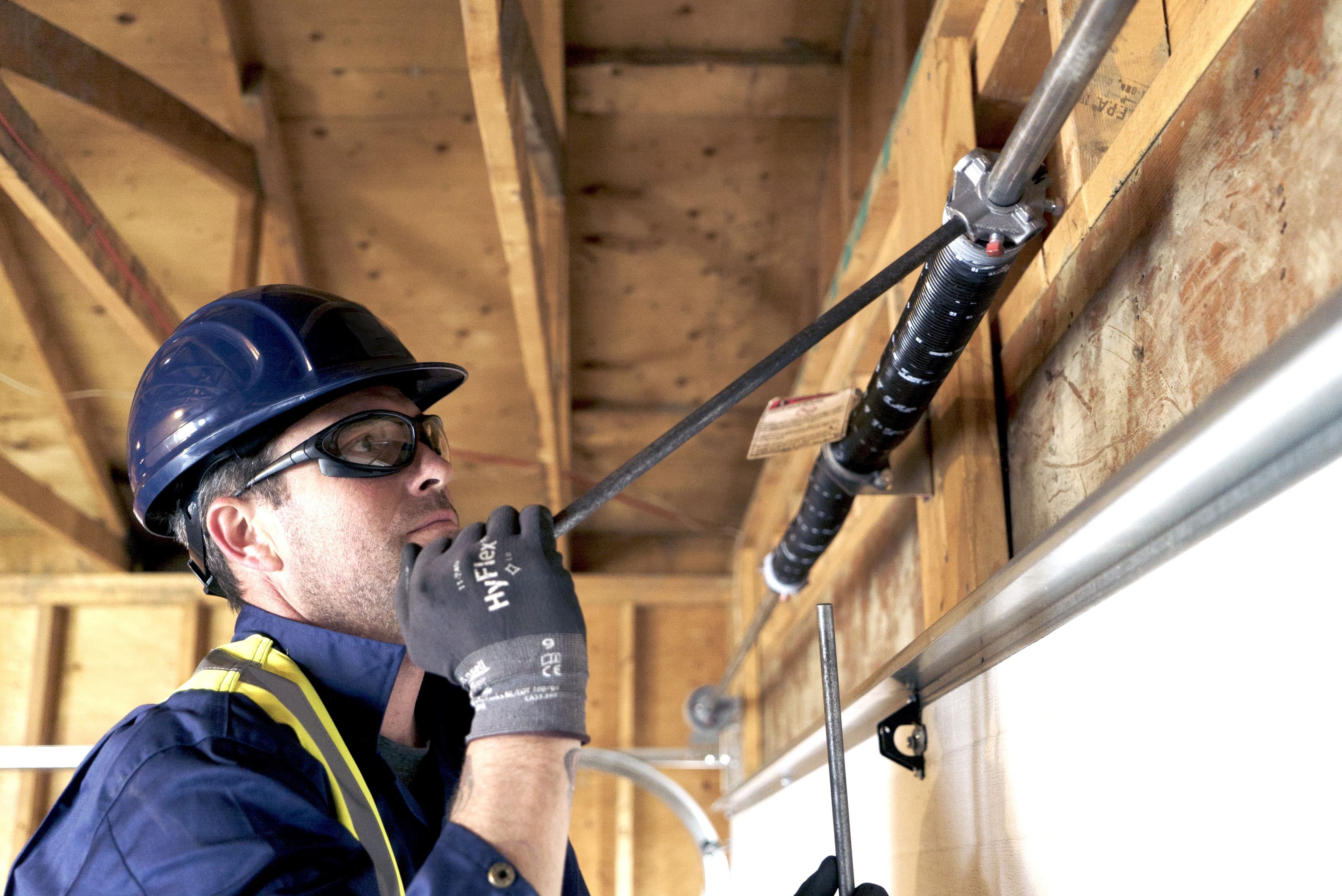 CDS technician performing garage door maintenance