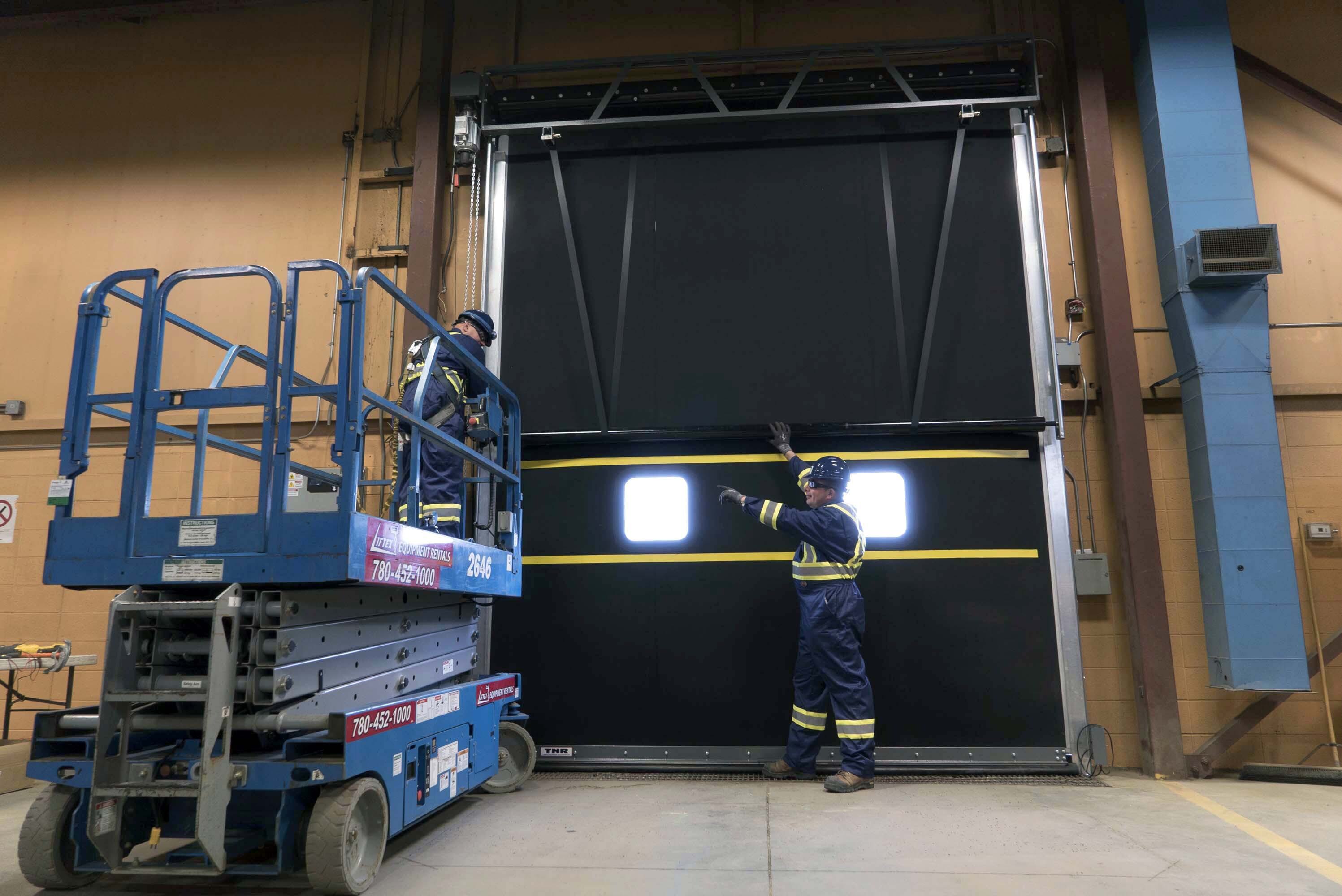 CDS technicians performing maintenance inspection on commercial door