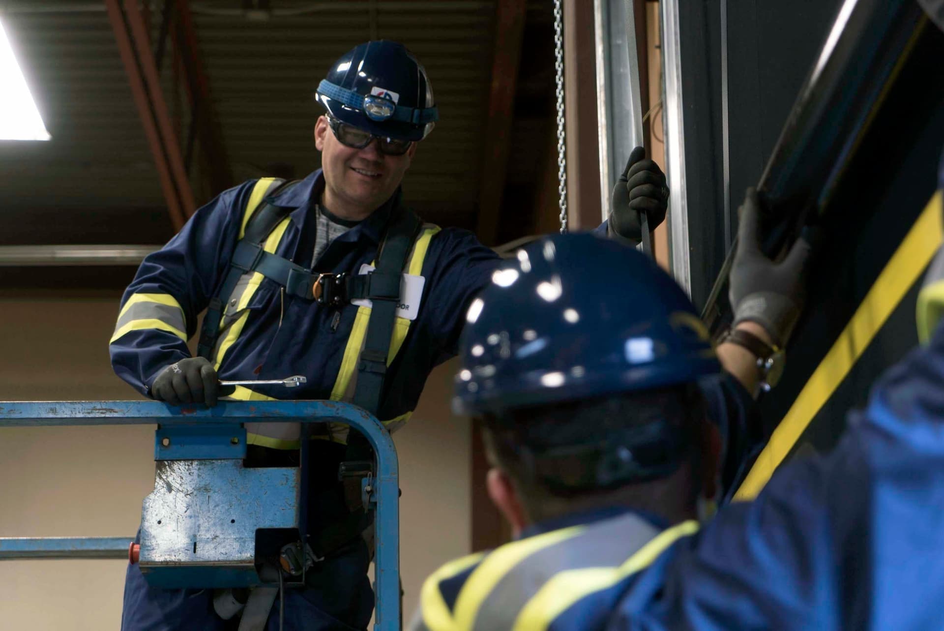 Creative Door Services technicians repairing warehouse door