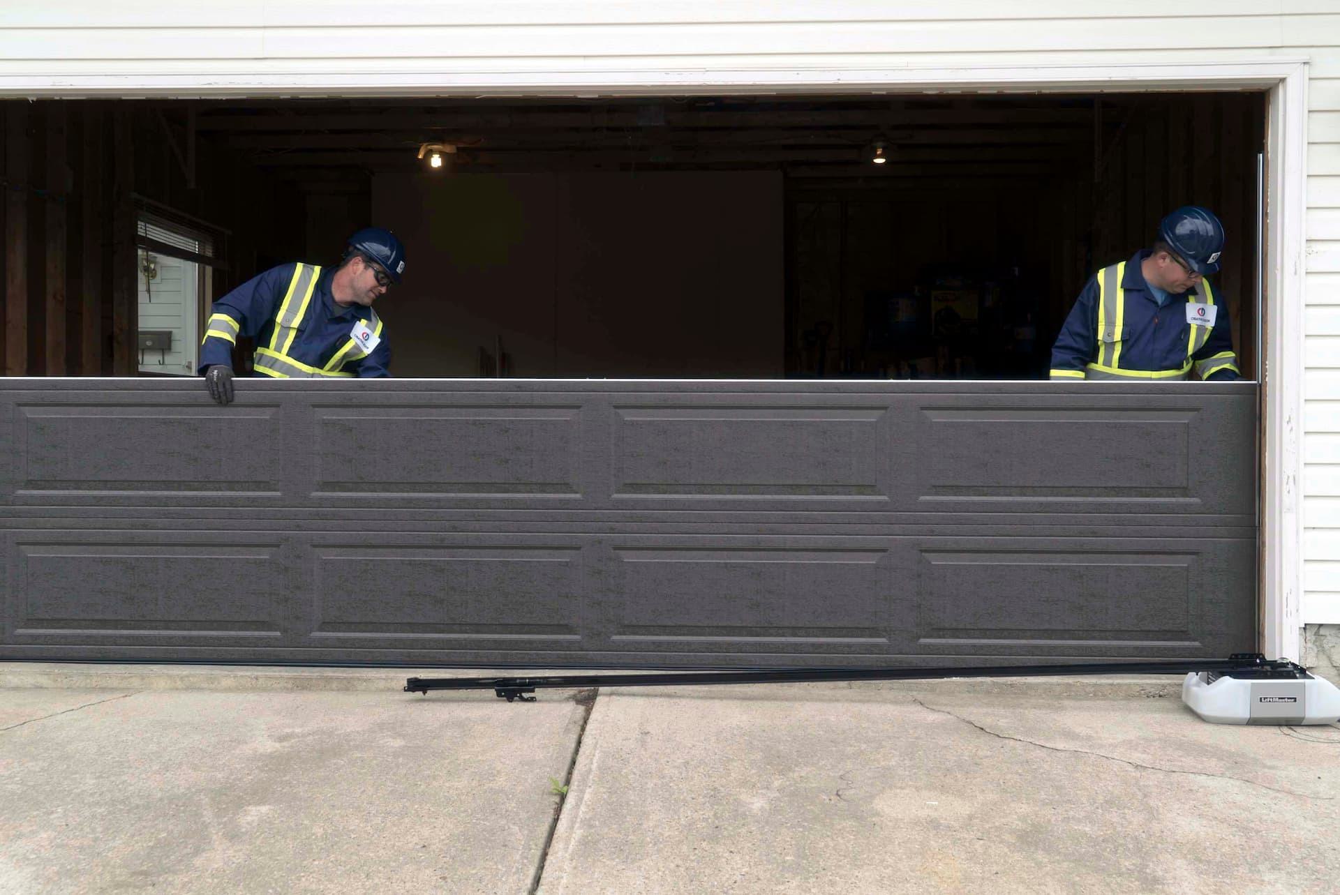 Creative Door Services technicians replacing garage door