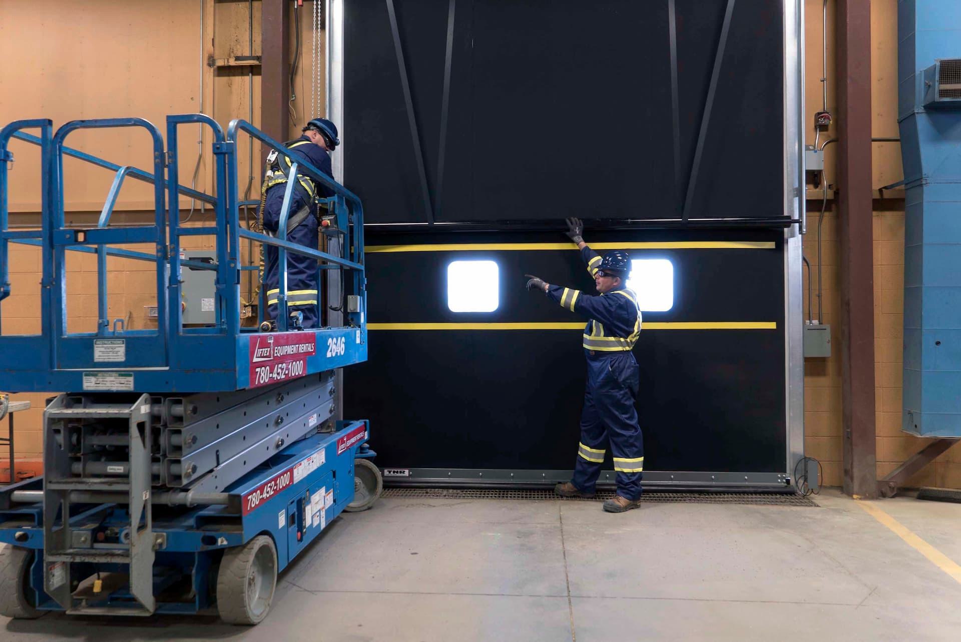 CDS technicians servicing high speed rubber door