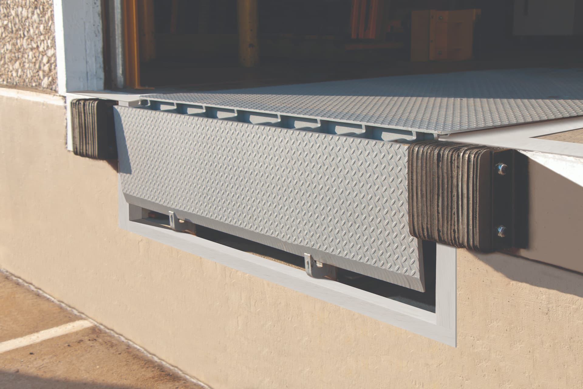 DaltonDock bumpers next to mechanical pit leveler