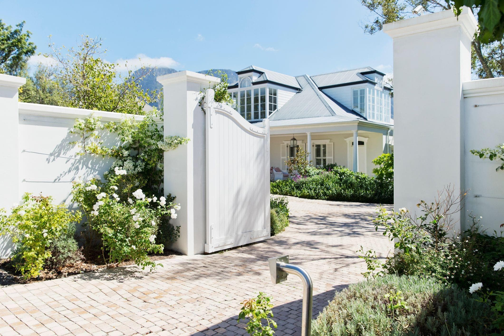 bright white wood driveway access gate to a home in Vancouver