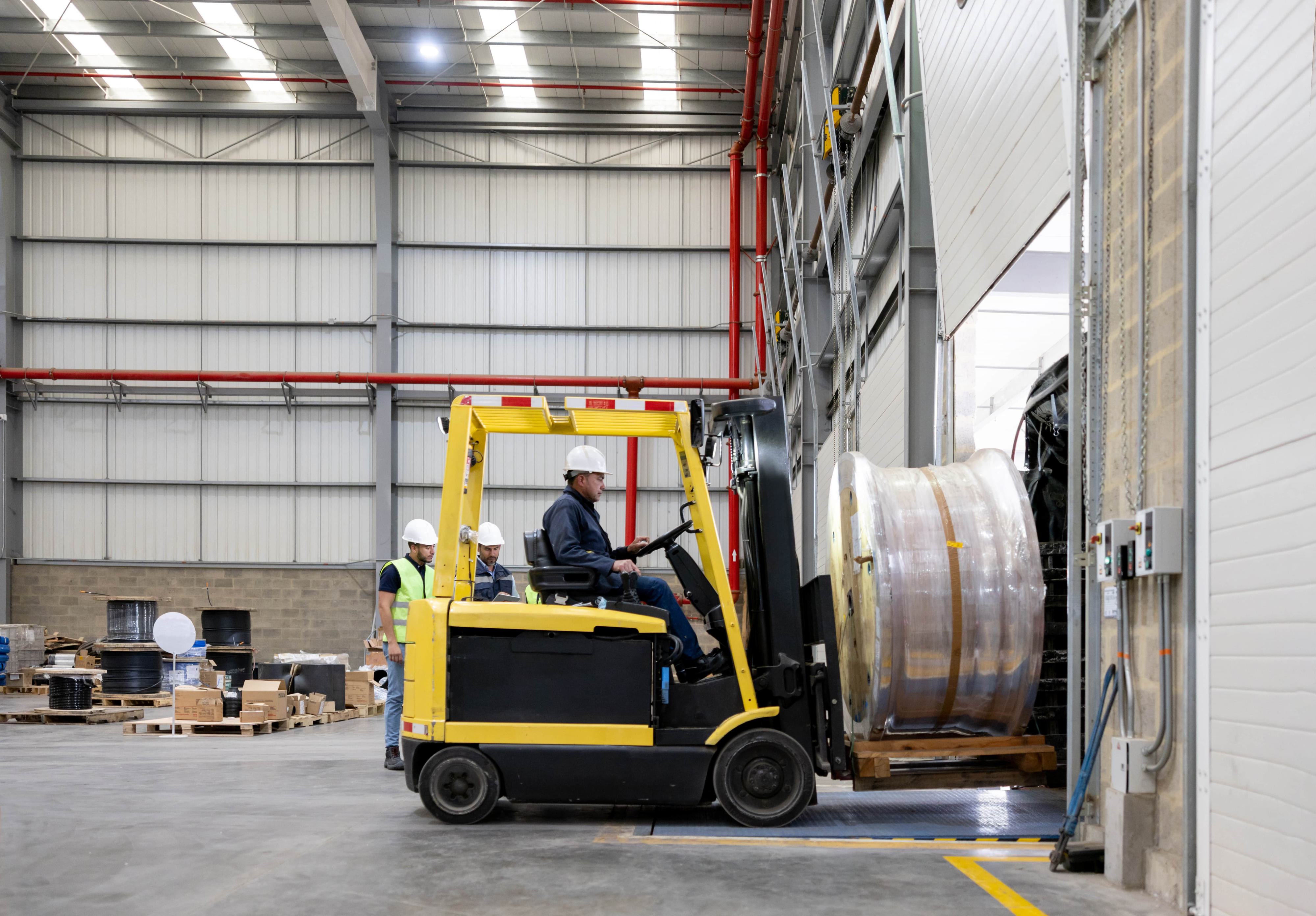 Employee working at a distribution warehouse and using a forklift