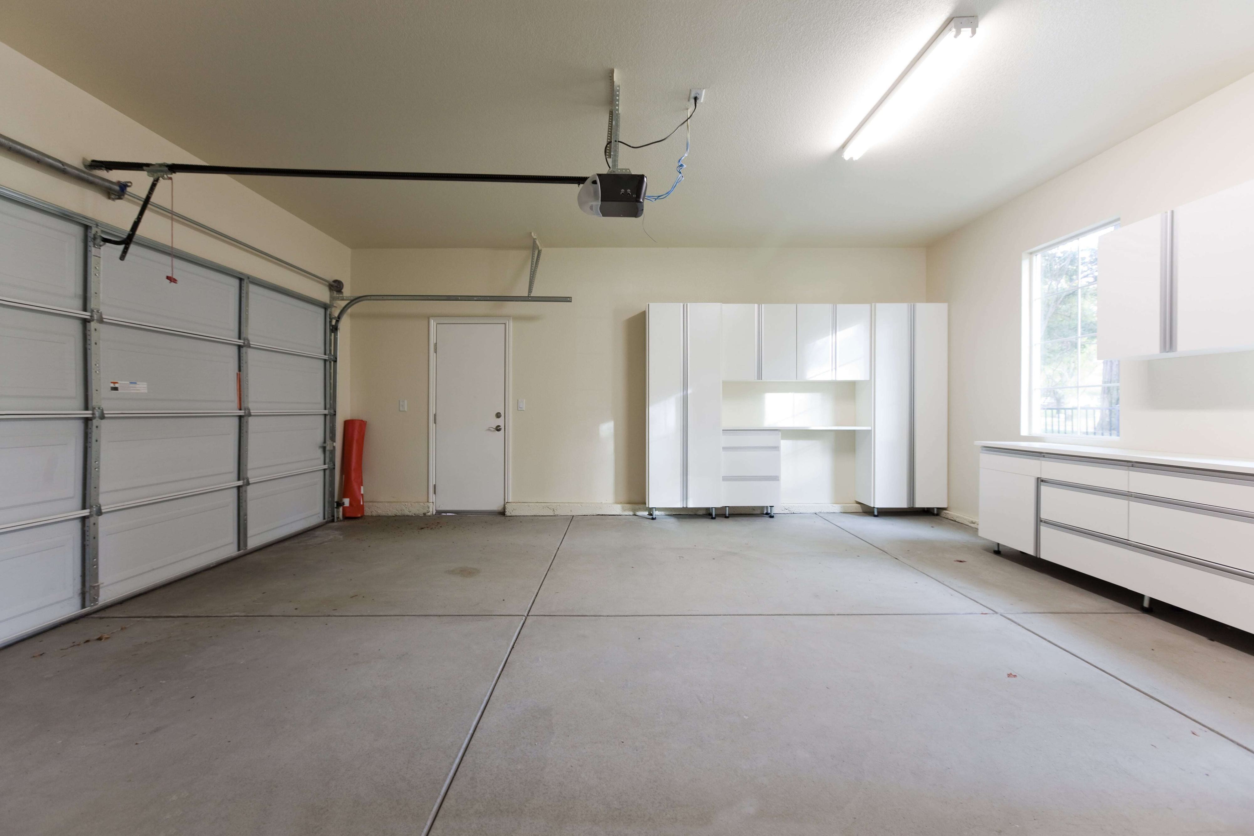 Empty garage interior with rear track hangers for the garage door