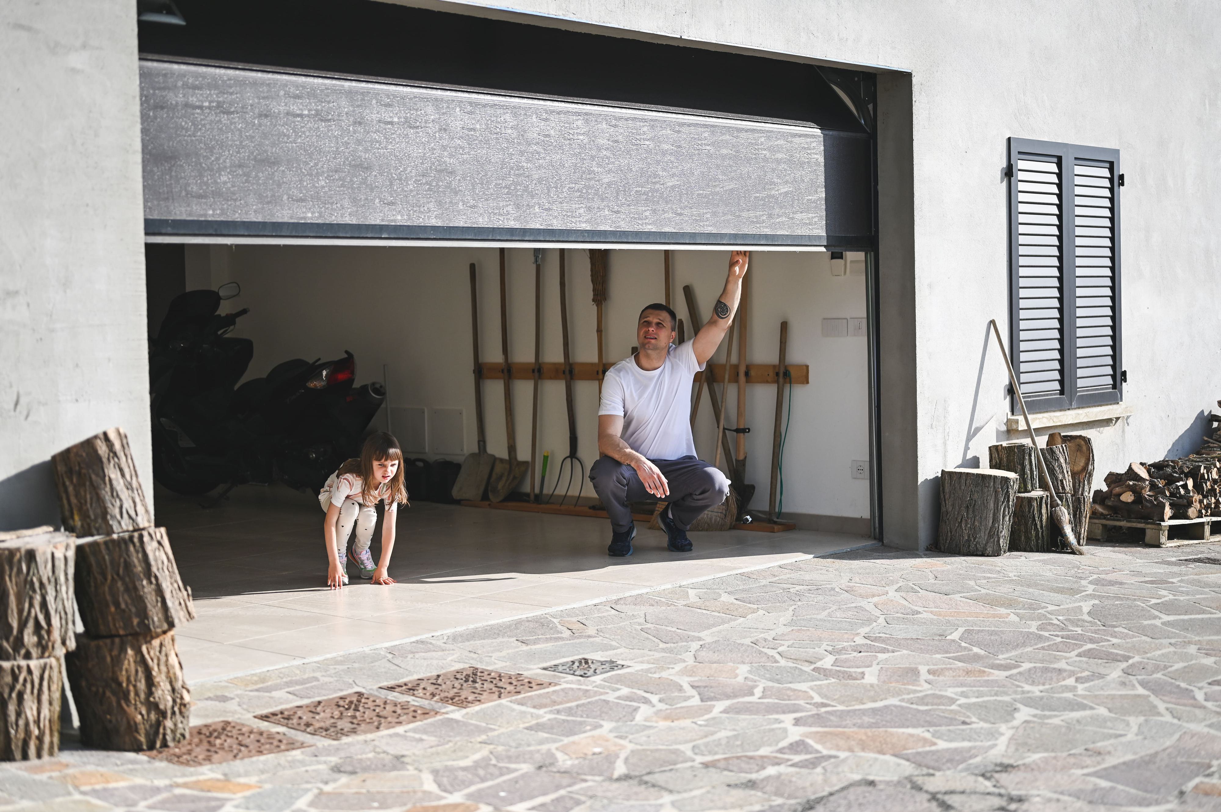 Garage door halfway open with family inside